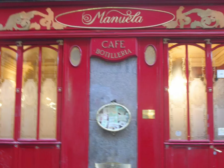 Traditional red wooden shopfront of a café in Malasaña, Madrid