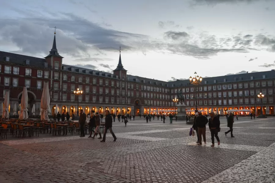 Plaza Mayor in Madrid in the evening, with its arcades and lamps lit