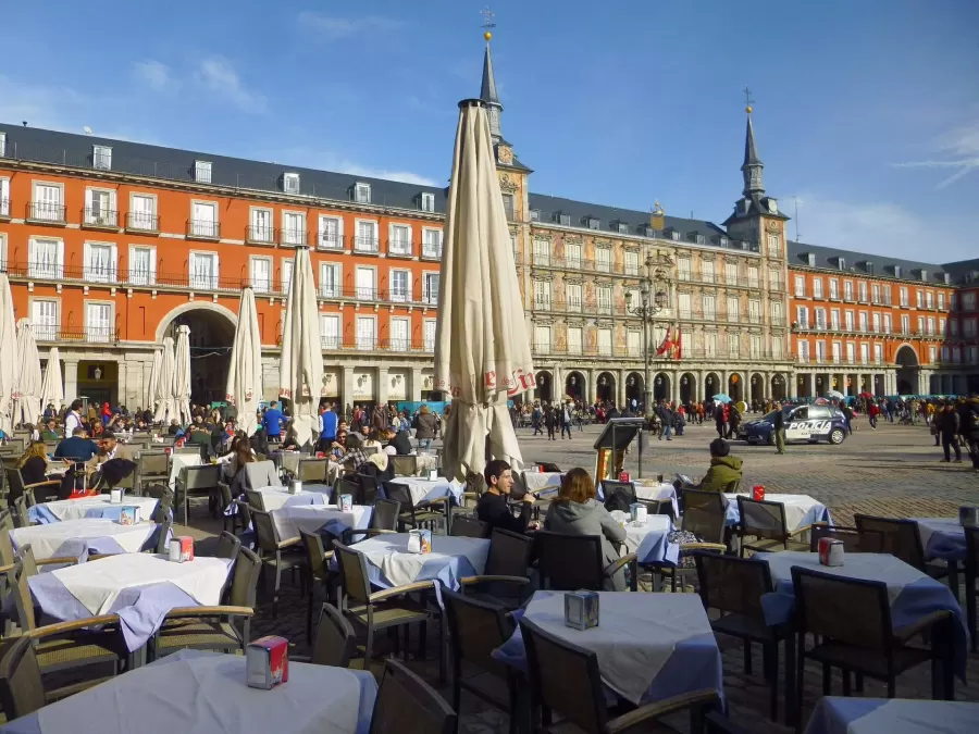 Café terraces in Plaza Mayor, Madrid, with the Casa de la Panadería facade